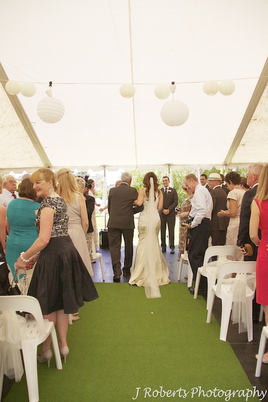 Bride down aisle in garden marquee - wedding photography sydney